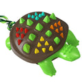 Natural rubber mint dog toothbrush chew toy with dinosaur knot tail in two-tone colours.