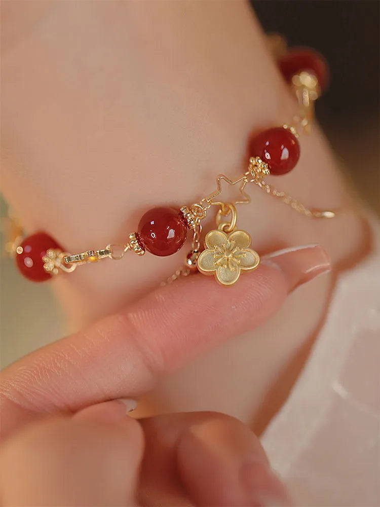 Red agate double layer bracelet for women with carved peach blossom and flower designs.