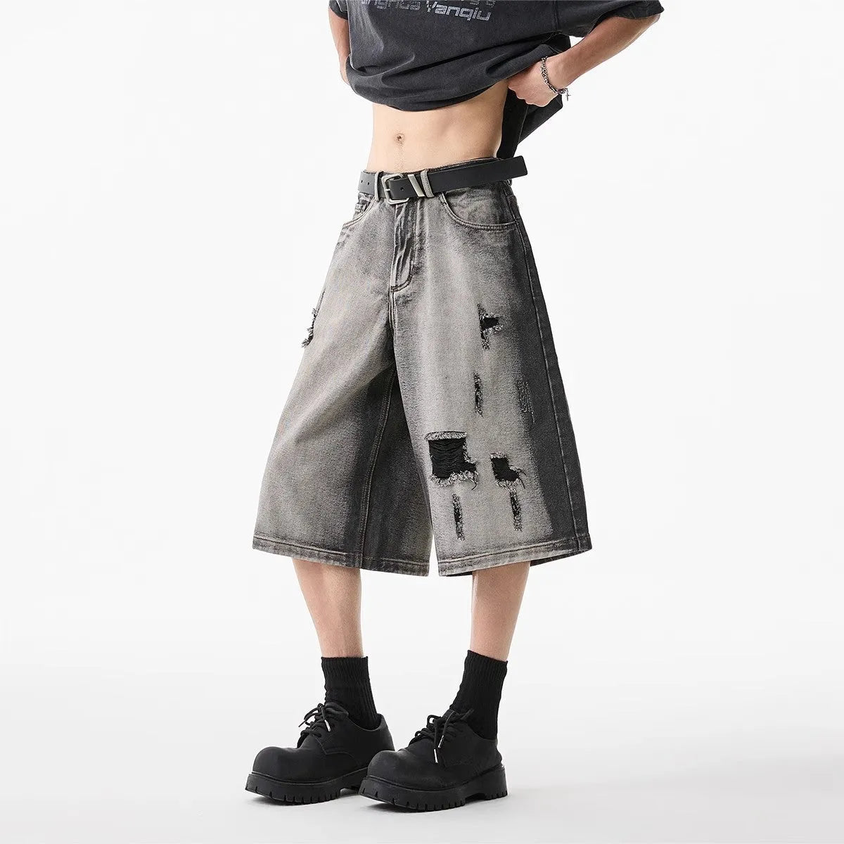 Grey loose-fit denim shorts with a water-washed finish and distressed hole details.