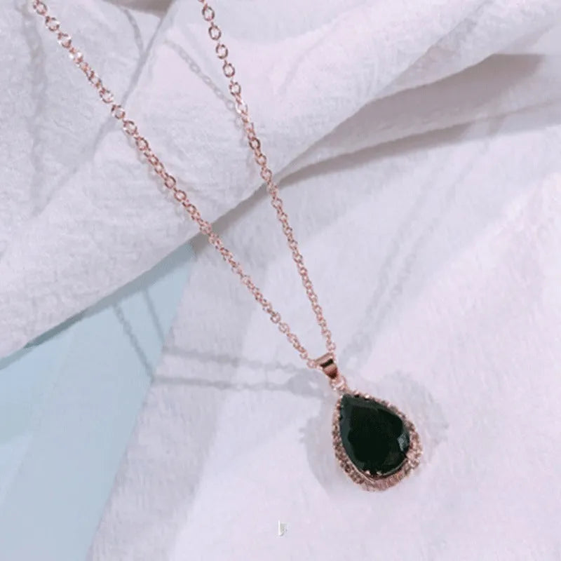 Pink water drop geometric necklace with rose gold electroplating and rhinestone detailing on alloy pendant