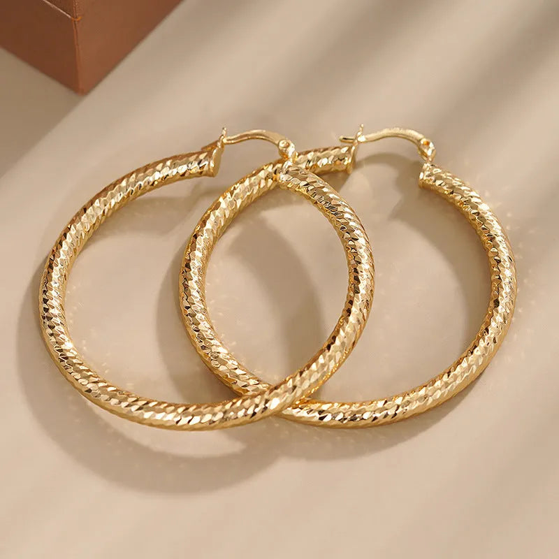 Women's geometric drop earrings with clip-on fastening in copper with ring and line design elements