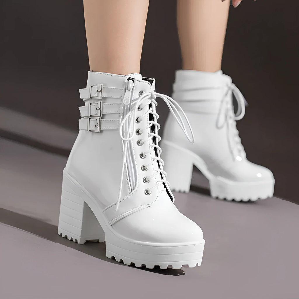 Women's black thick-heeled lace-up ankle boots with a round toe and rubber sole on a waterproof platform.