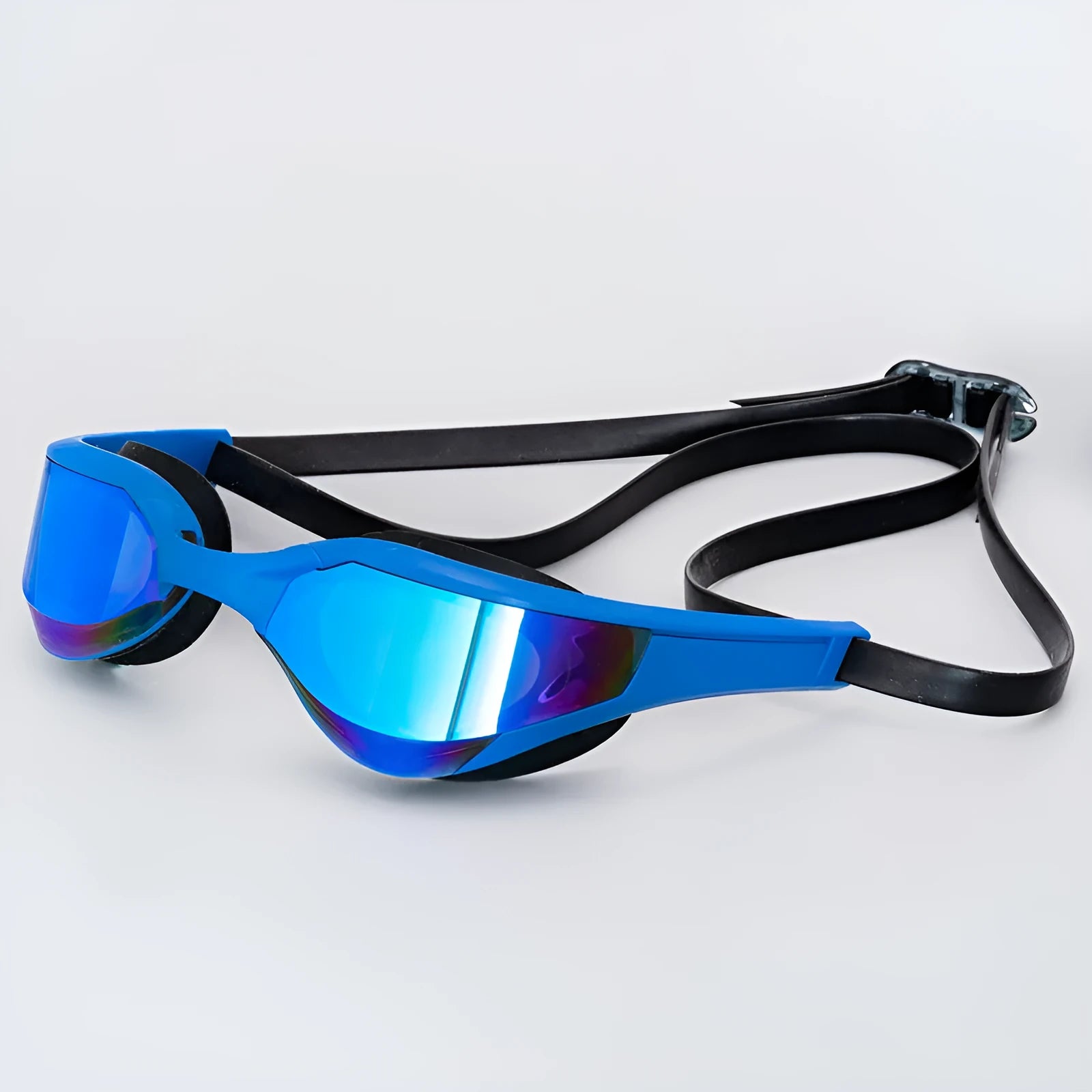 Anti-fog swimming goggles with polycarbonate lenses shown with large and small nose bridges in a plastic mirror box.