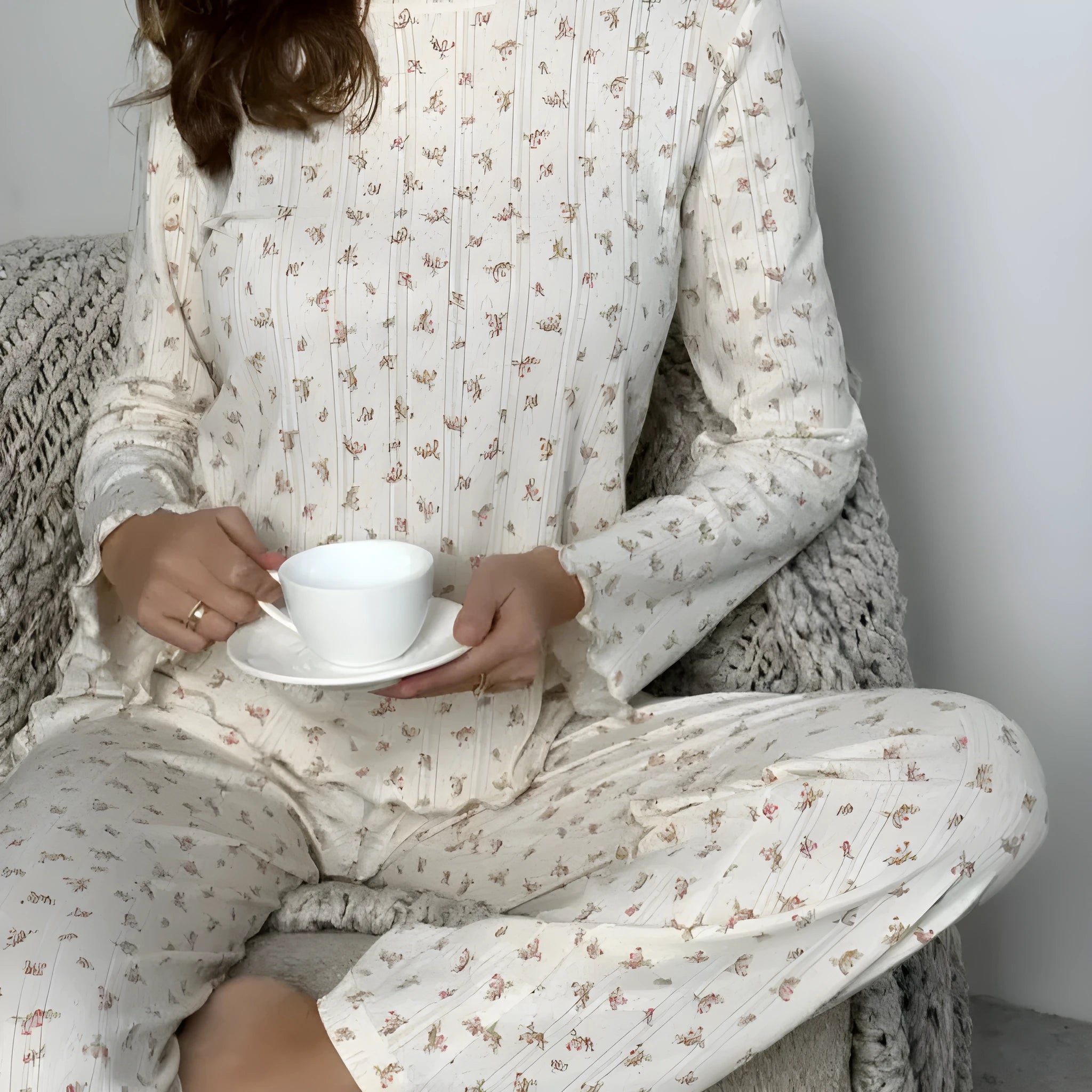 White floral print women's loungewear suit with bell sleeve top and wide-leg trousers.