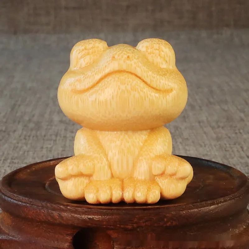 Small smiling frog ornament carved from solid bamboo measuring 5cm in height