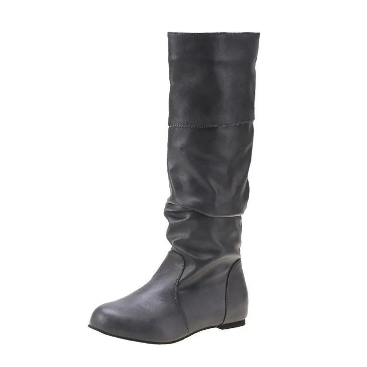 Women's black slip-on flat boots with round toe and high cylinder design on a neutral background.