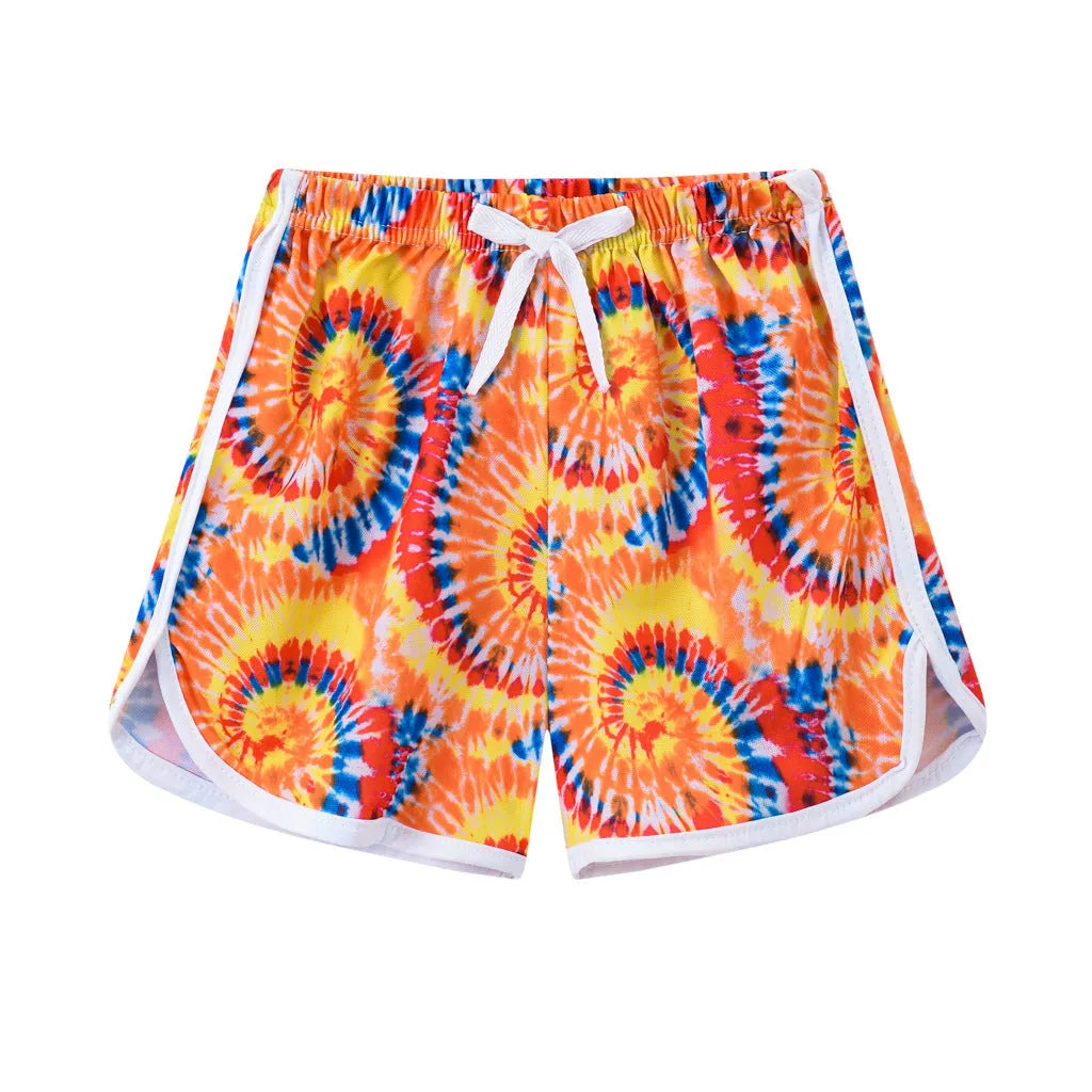 Children's patterned beach shorts in various colours including leopard print, floral, and fruit designs