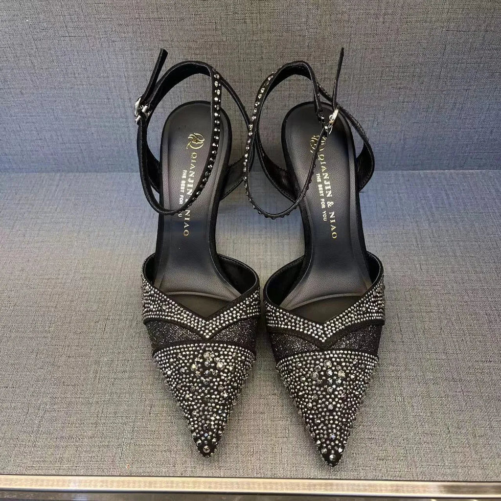 Women's black and silver hollow high heels with red stiletto soles and pointed toes.