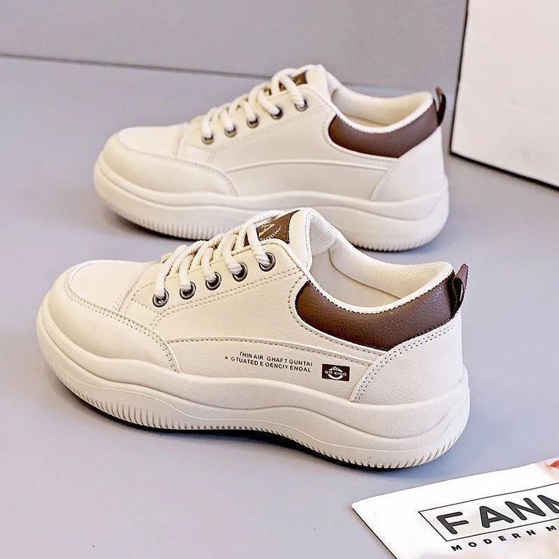 Women's white Korean-style low-top pumps with cross straps and round toe on a rubber sole.