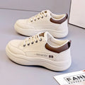 Women's white Korean-style low-top pumps with cross straps and round toe on a rubber sole.