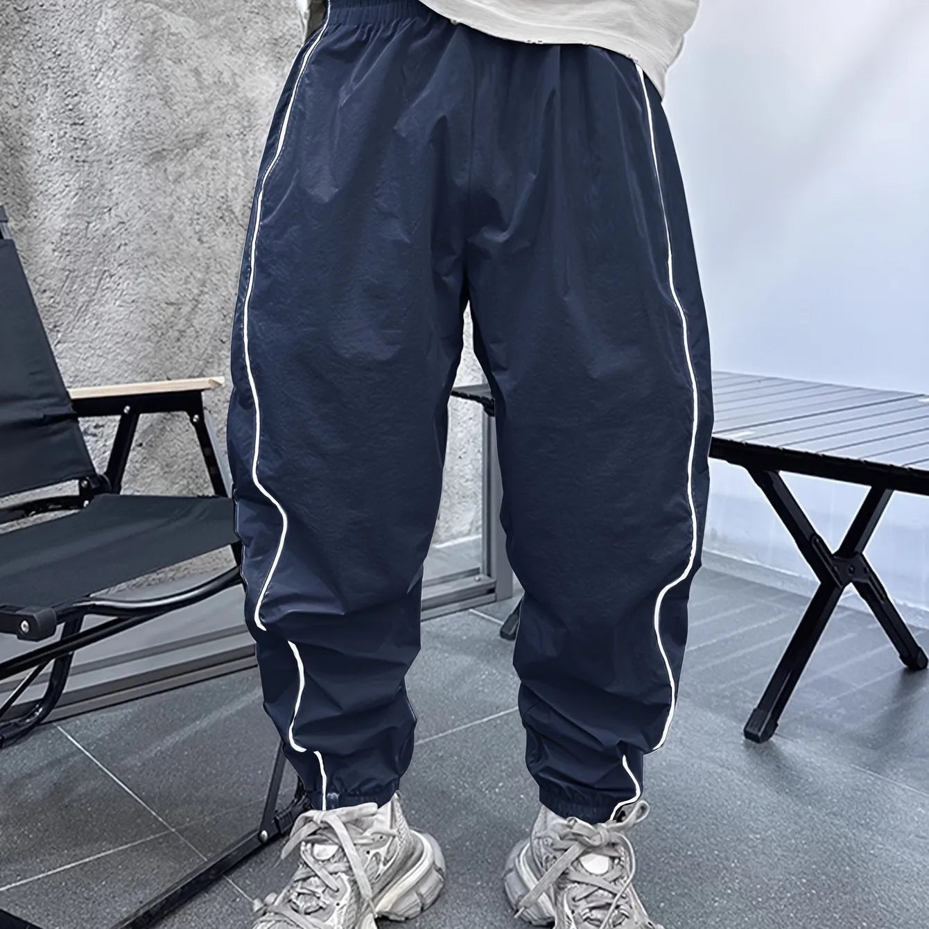 Man wearing blue bamboo fibre casual trousers with a cropped leg and loose fit.