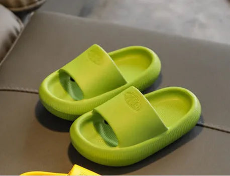 Children's non-slip EVA slippers in bright colours, showing the 1.5cm thick sole.