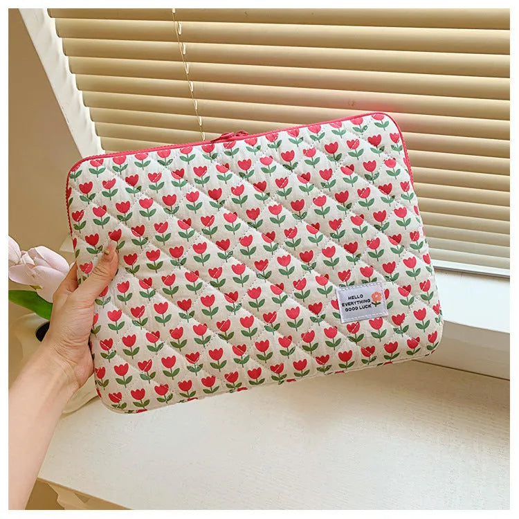 Floral print cloth laptop bag showing green flower pattern with storage compartments and anti-seismic protection