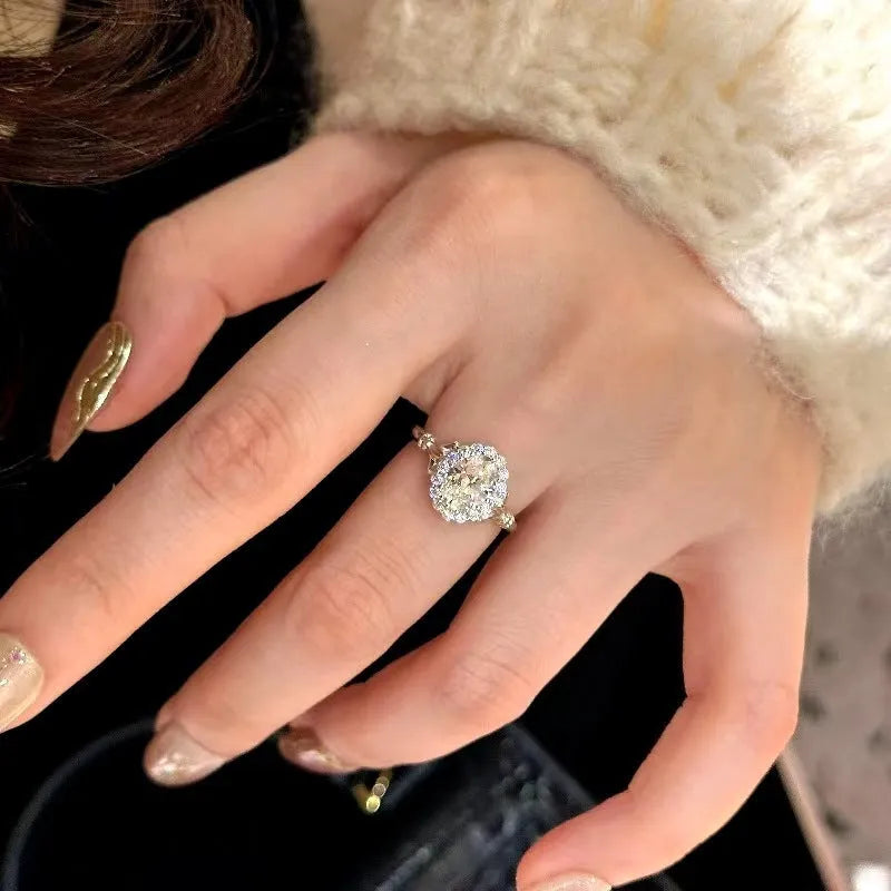 Silver geometric bridal bouquet ring with adjustable opening and diamond-treated elliptical element
