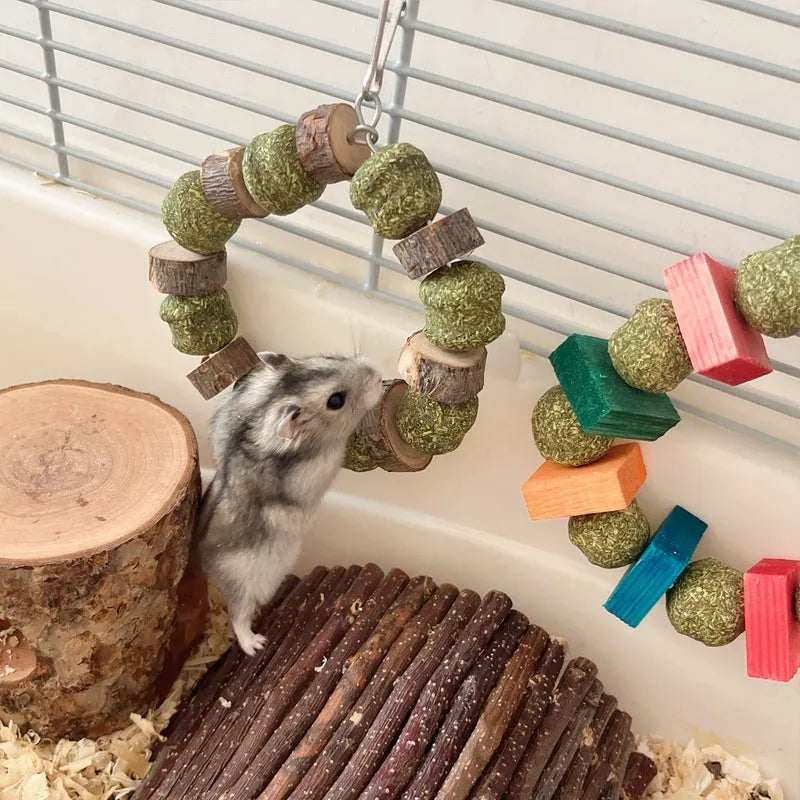 Applewood and woven straw ball chew ring toy for small pets on a white background.