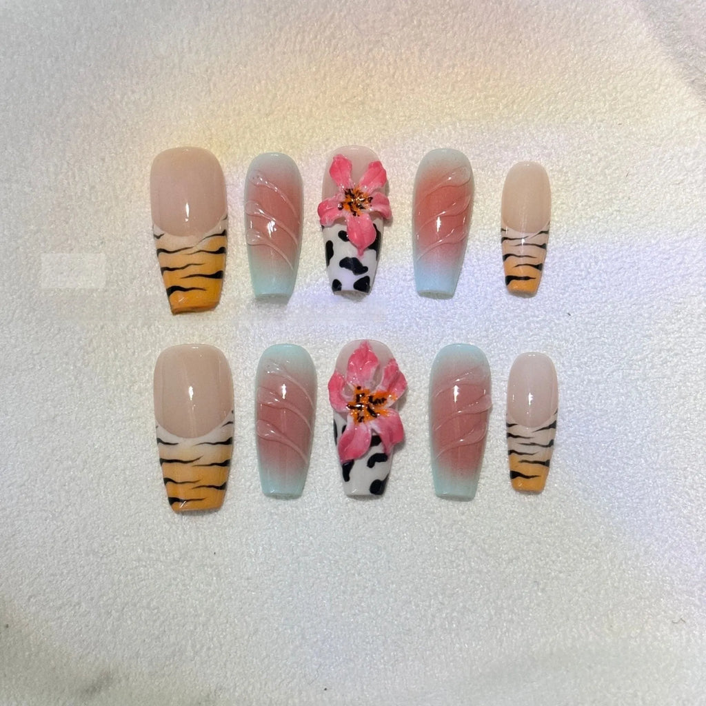 Set of nail art stickers showing zebra pattern and lily flower designs with embossed texture.