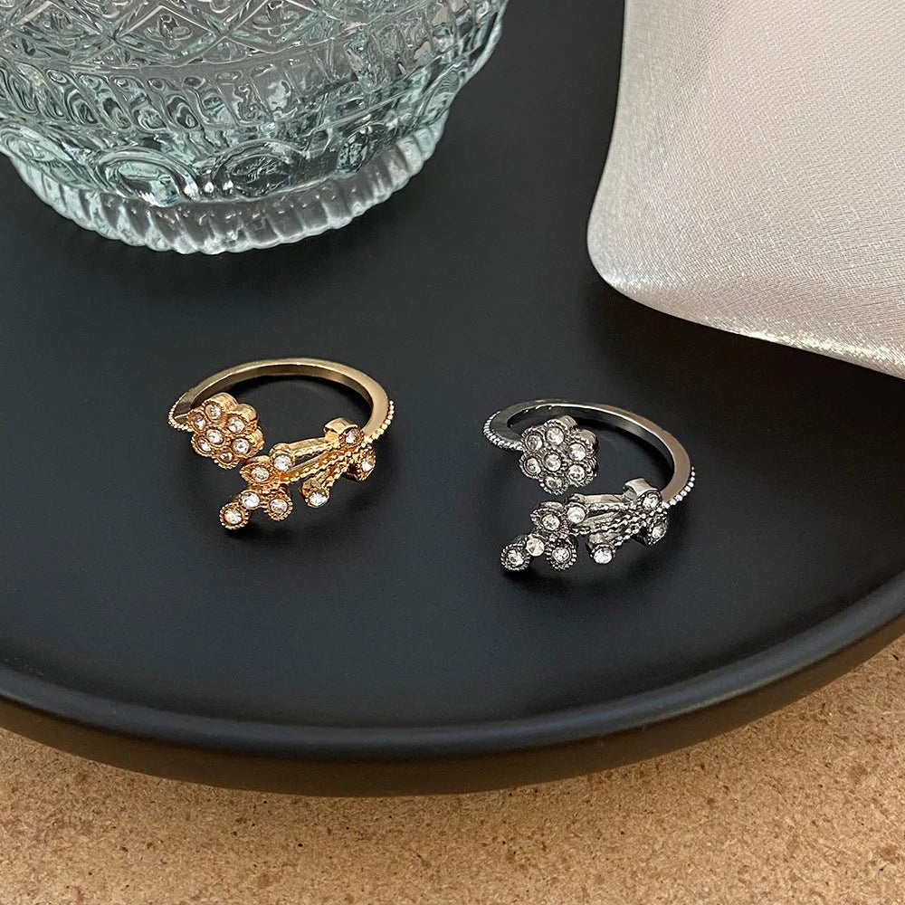 Women's open copper ring with diamond-treated floral and leaf design in gold colour.