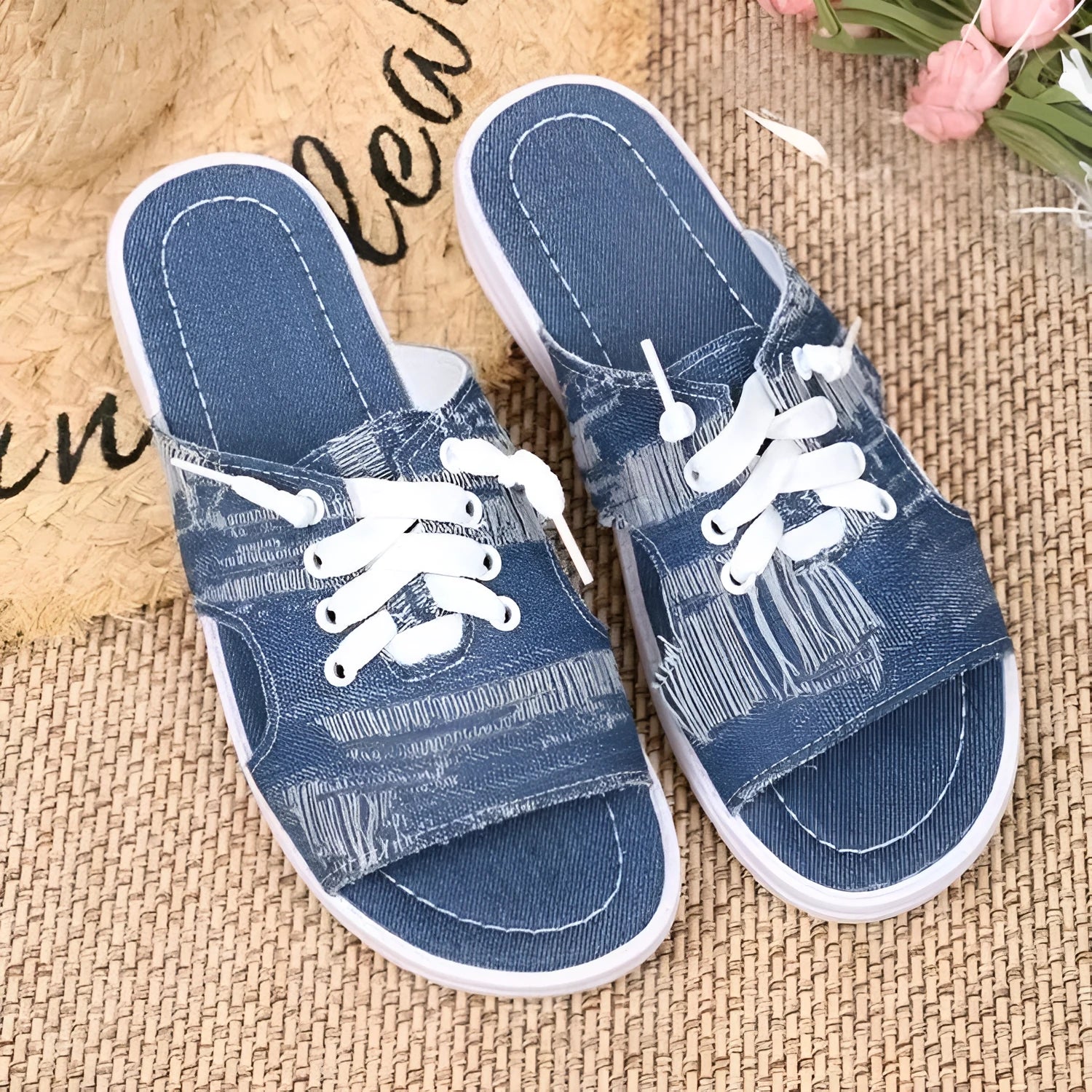 Blue women's flat canvas Roman style slippers with a cloth upper and rubber sole.