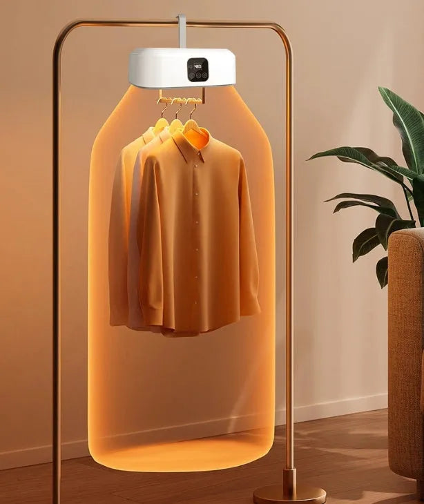 White foldable portable clothes dryer with remote control on countertop