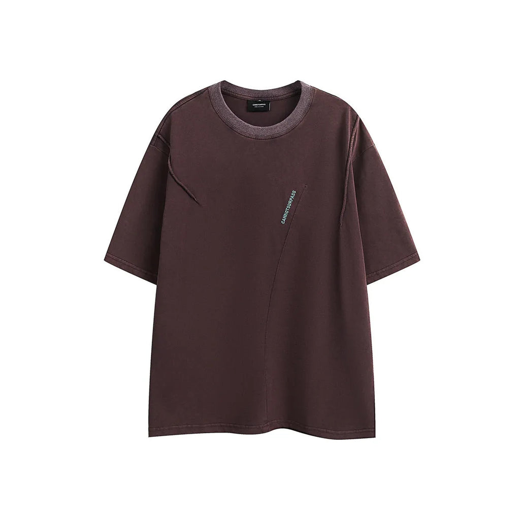 Purple and black loose-fit short-sleeved cotton t-shirt with embroidered retro design on a washed fabric.