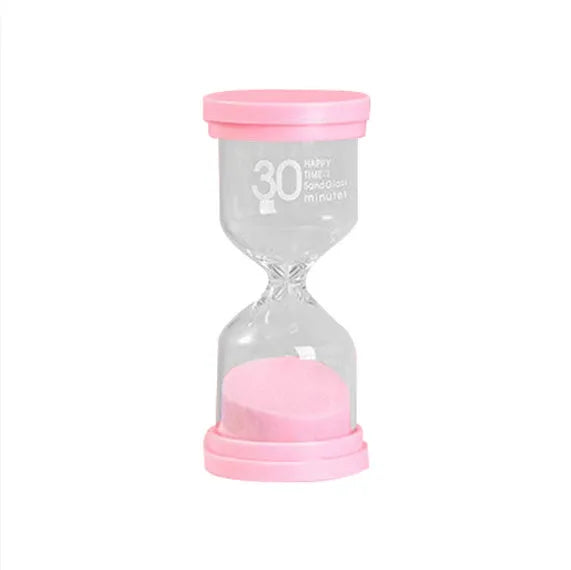 Handmade glass sand clock timer on a desk, showing purple sand, modern design.