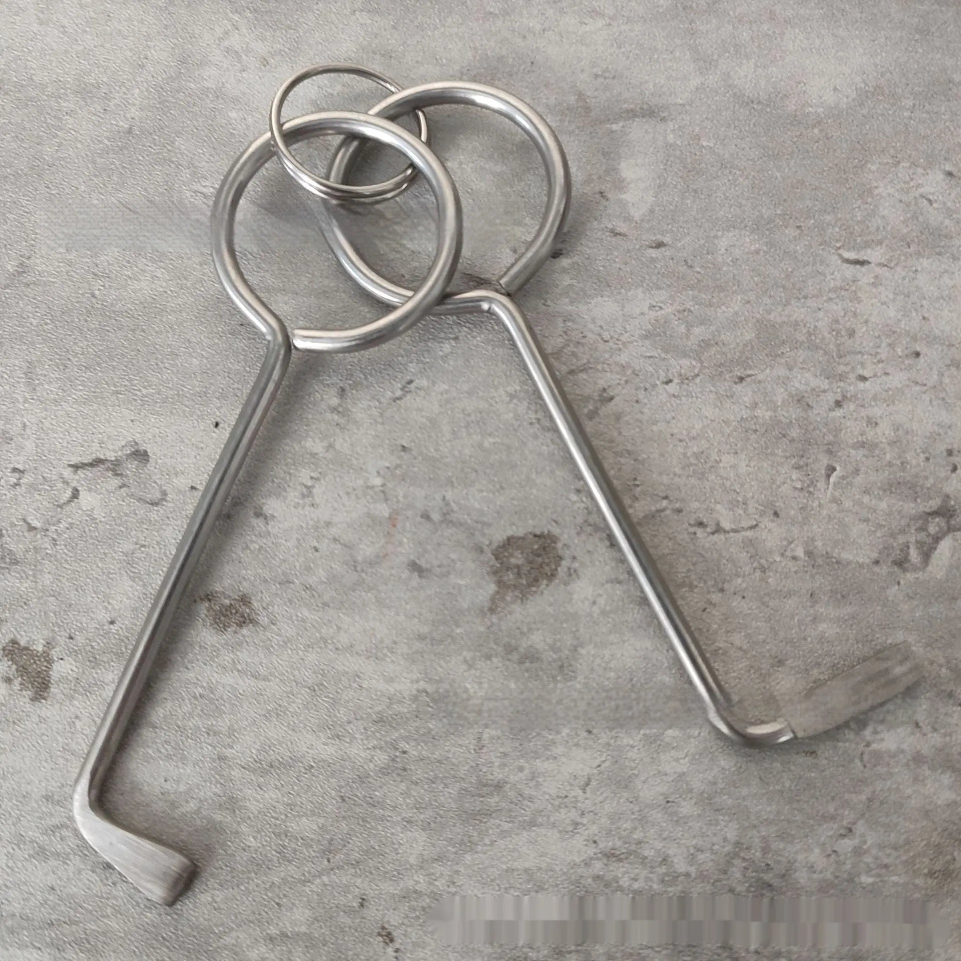 Two alloy steel wrench tools from a portable household repair set.