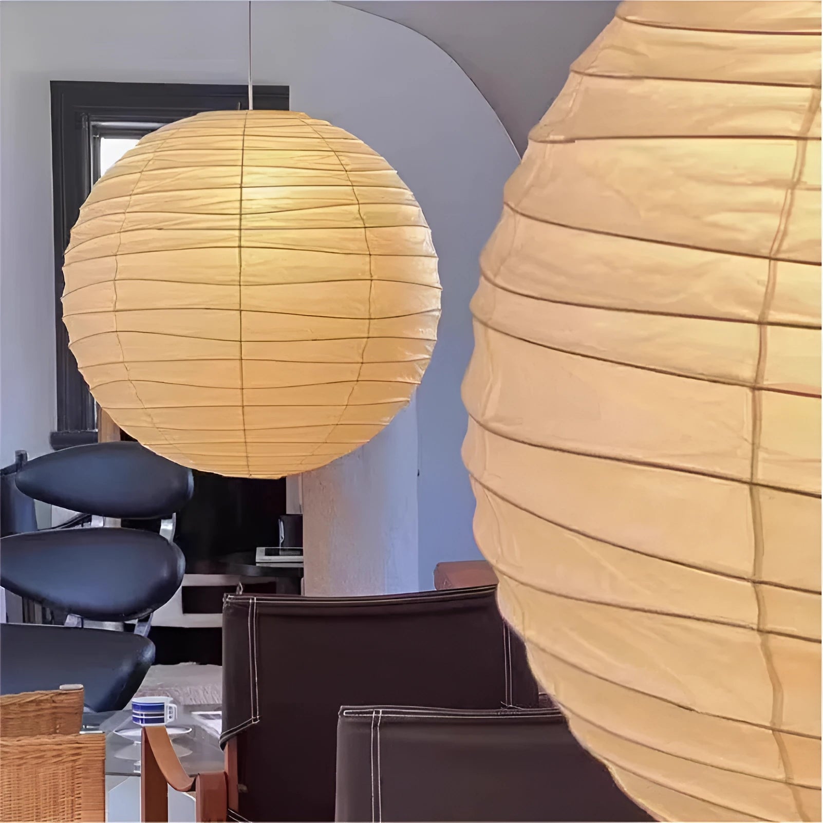 Japanese style white rice paper pendant chandelier with a woven frame, shown in a room setting.