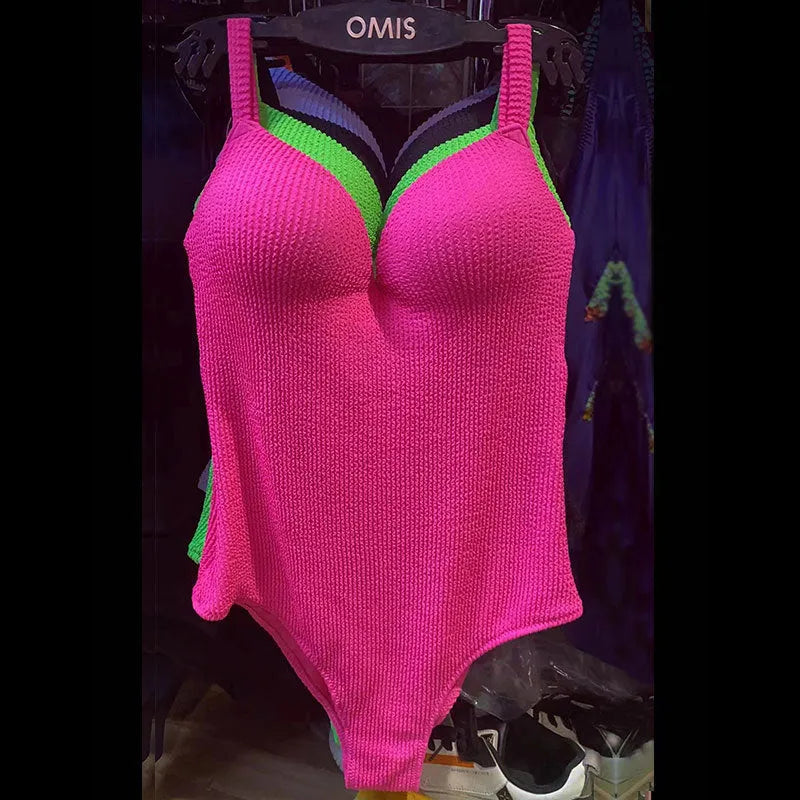 Women's black one-piece sleeveless swimsuit with a sunken stripe pattern on a mannequin.