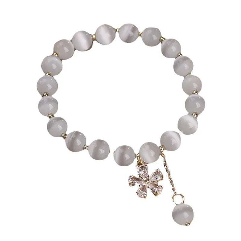 White cat's eye stone women's bracelet with flower tassels and safety buckle