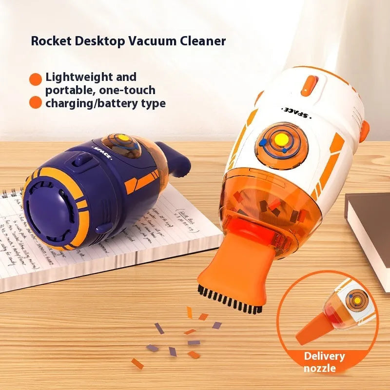 USB charging handheld desktop vacuum cleaner in blue rocket design on computer keyboard