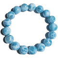 Blue Maillard style Bodhi bracelet with a natural sea-pattern crystal stone and pearl beads on wrist.