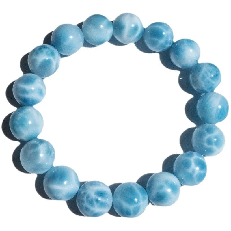 Blue Maillard style Bodhi bracelet with a natural sea-pattern crystal stone and pearl beads on wrist.