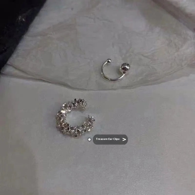 A pair of frosty-finish geometric alloy earrings with ear clip fastenings.