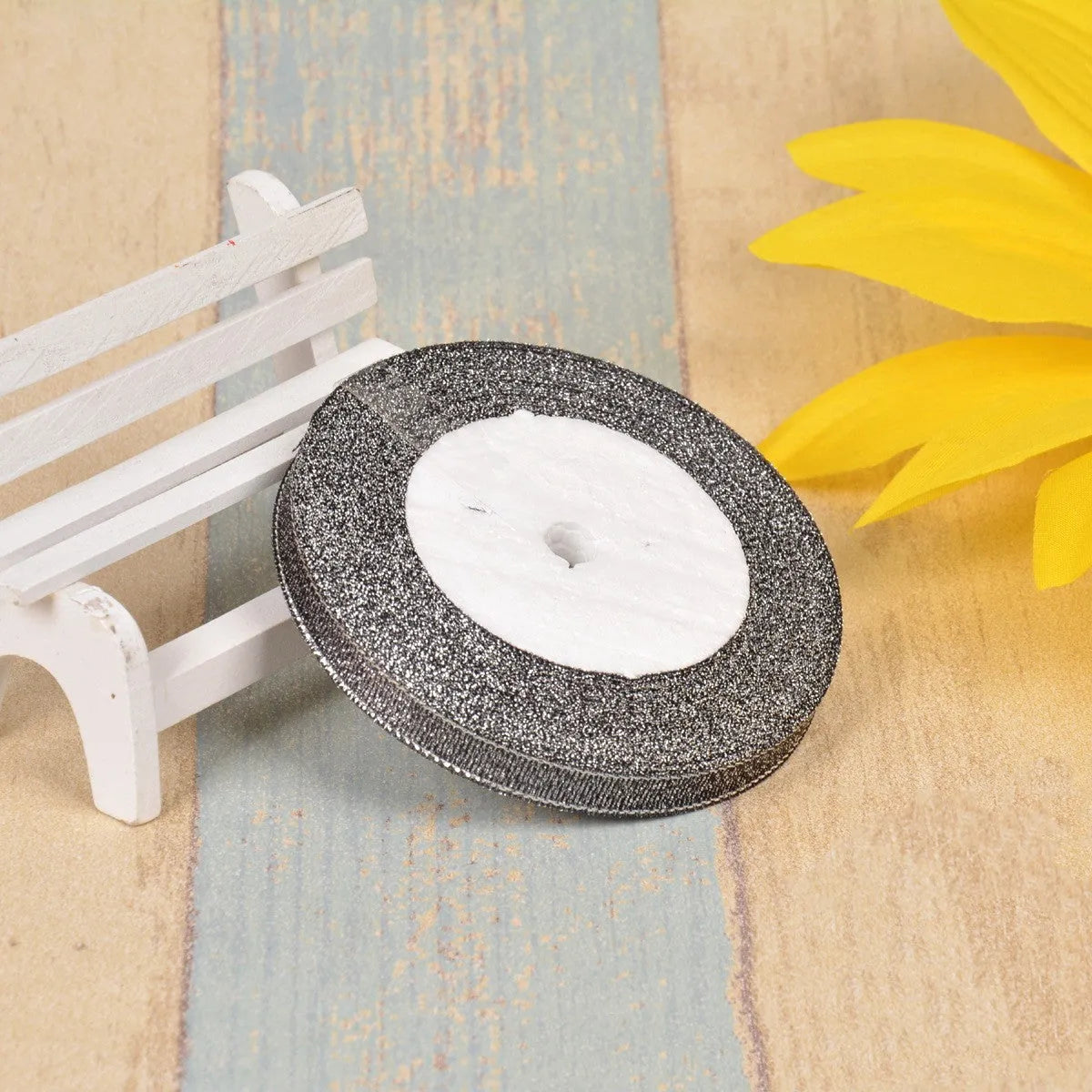 Polyester ribbon spool in metallic colours for decorative clothing and gift packaging trim