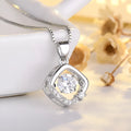 Heart-shaped sterling silver necklace with crown and bow charms on model