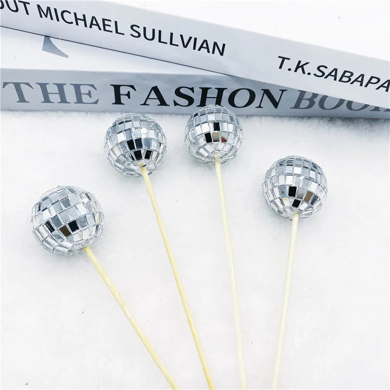 Glass disco ball cake decoration on a wooden stick, shown in different sizes for cake topping.