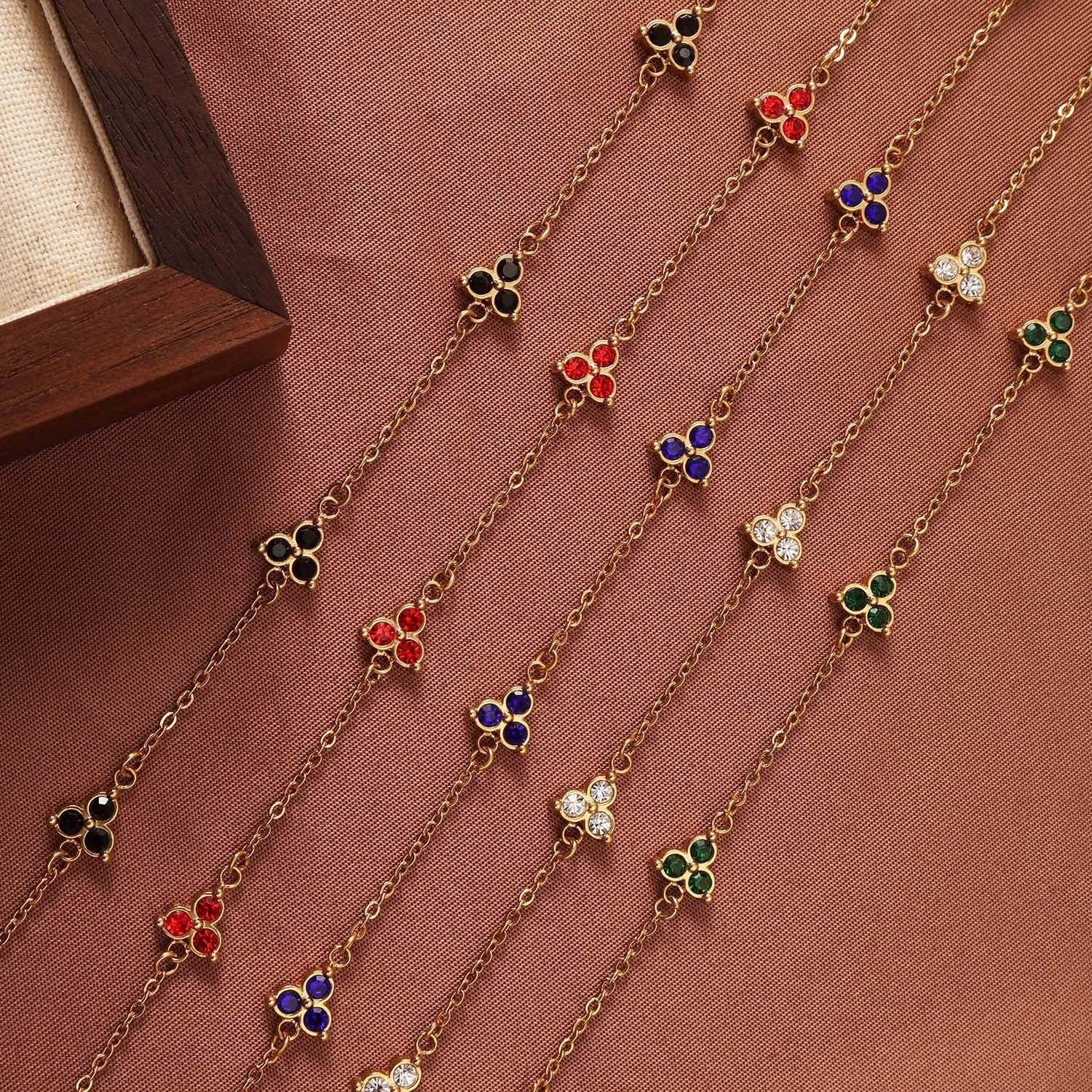 Women's stainless steel geometric triangle bracelet with a three-diamond pattern, shown in a gold and white zircon colour option.