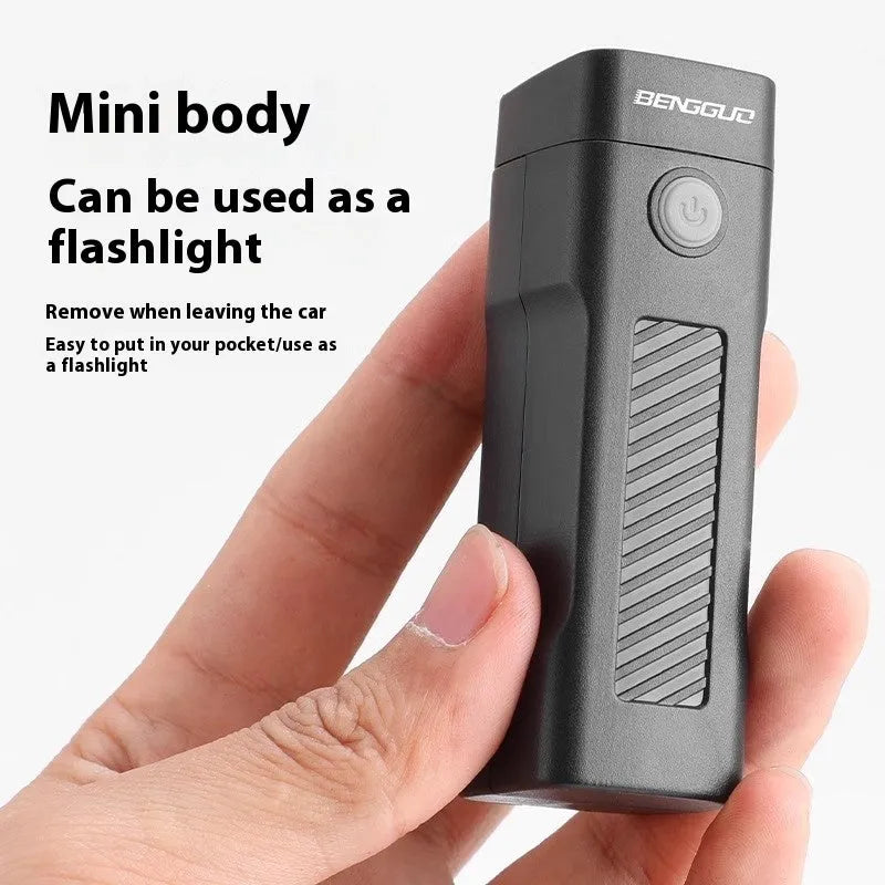 A black USB-rechargeable bicycle headlight mounted on a handlebar with a quick-release strap.