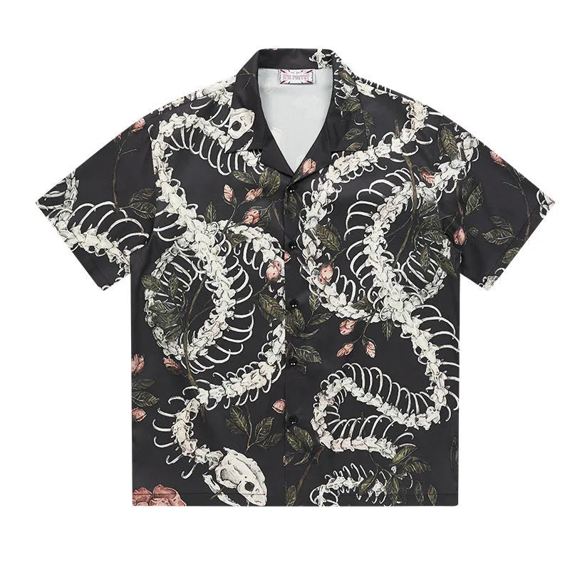 Man wearing a loose fit short sleeve Cuban collar shirt with a snake bone and floral pattern print.