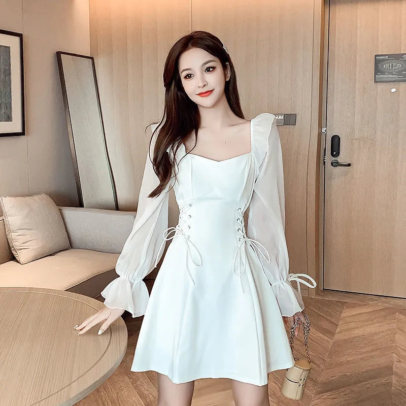 White women's chiffon dress with patchwork pattern and long sleeves, shown in a waist-slimming fit.