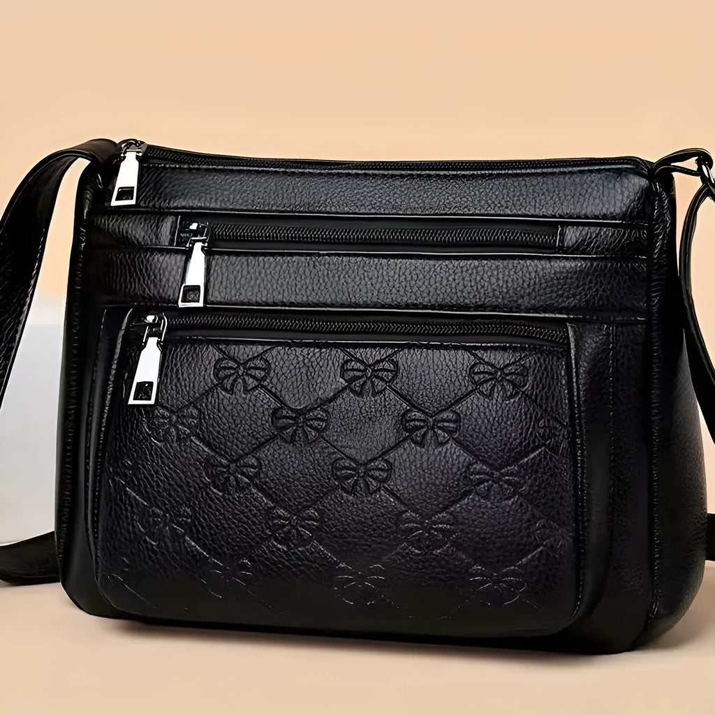 Butterfly black PU leather women's crossbody messenger bag showing embossed pattern and horizontal square shape