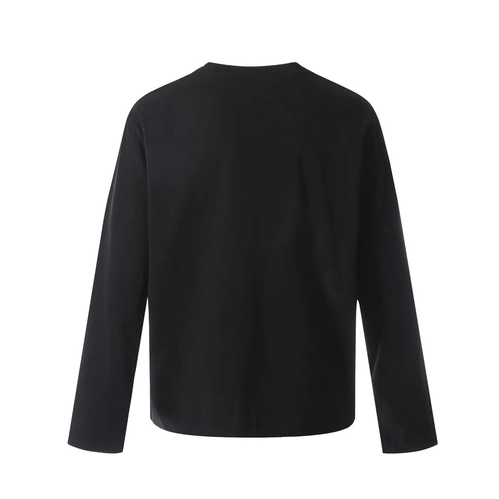 Man wearing a loose fit grey long sleeve cotton t-shirt for casual wear.