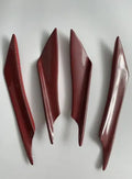 Set of four black ABS plastic bumper blade spoilers for car modification on a white background.