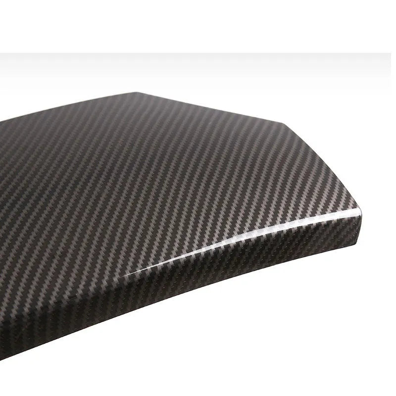 Three ABS armrest box protective covers with carbon fibre diagonal weave pattern showing polished shiny surface