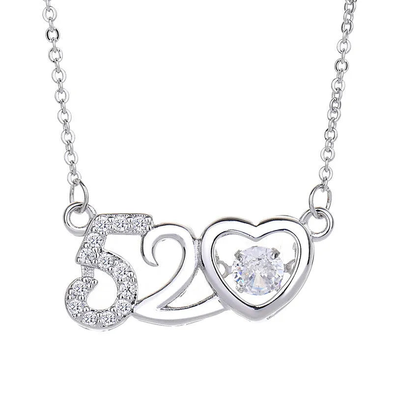 Heart-shaped sterling silver necklace with crown and bow charms on model