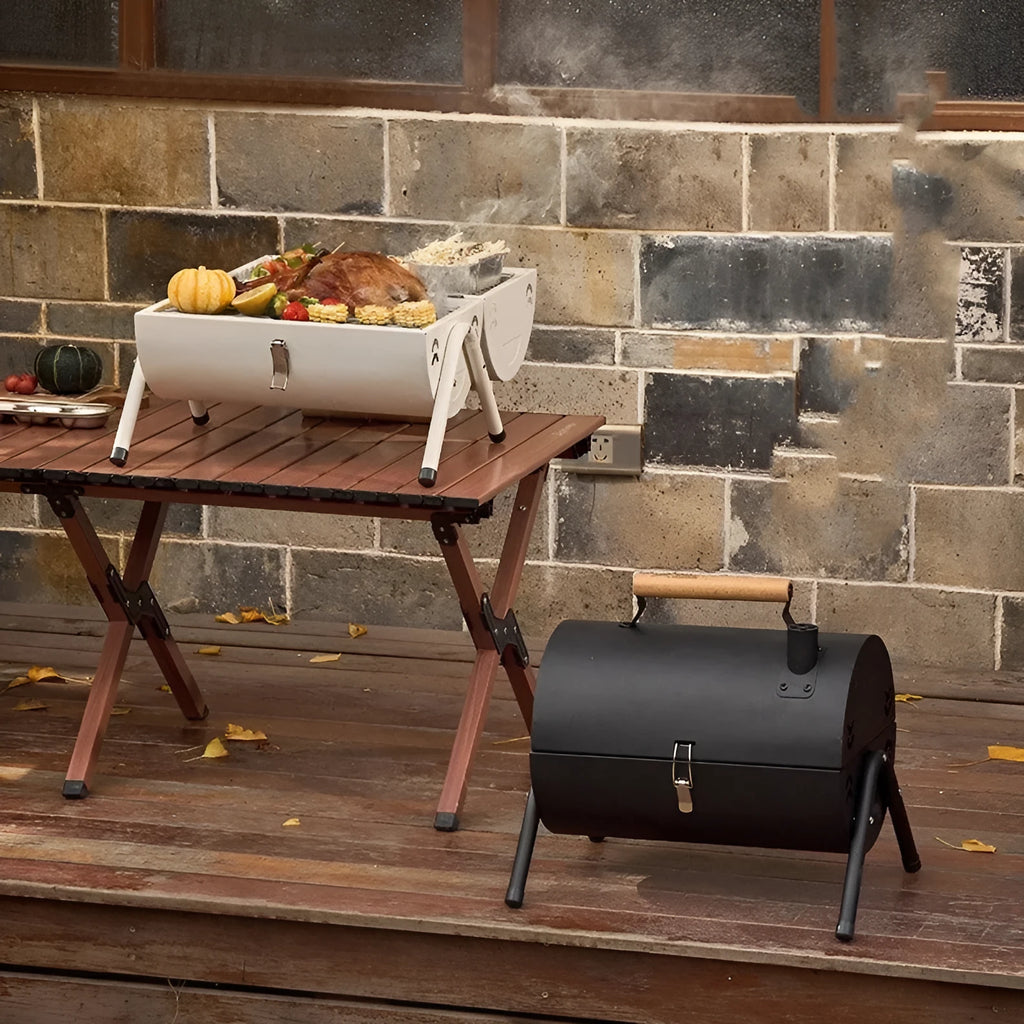 White portable folding barbecue grill with detachable rust-proof carbon tank for outdoor frying and baking.