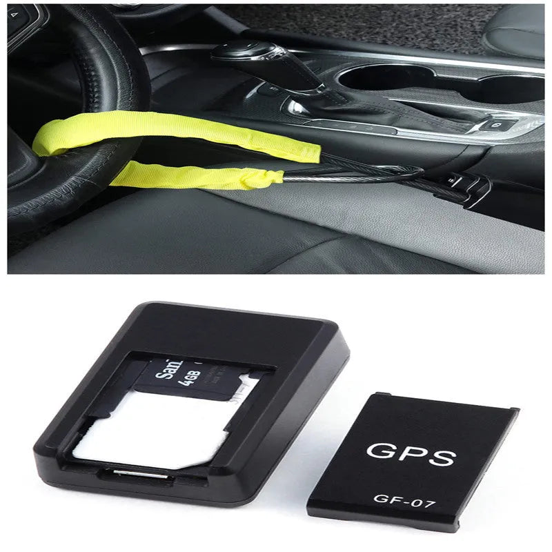 Small black plastic magnetic GPS car tracker device on a metal surface.