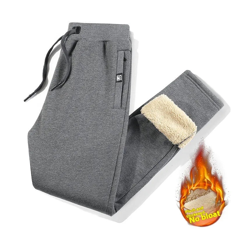 Men's grey fleece-lined oversized cotton track pants with an elastic mid-waist.