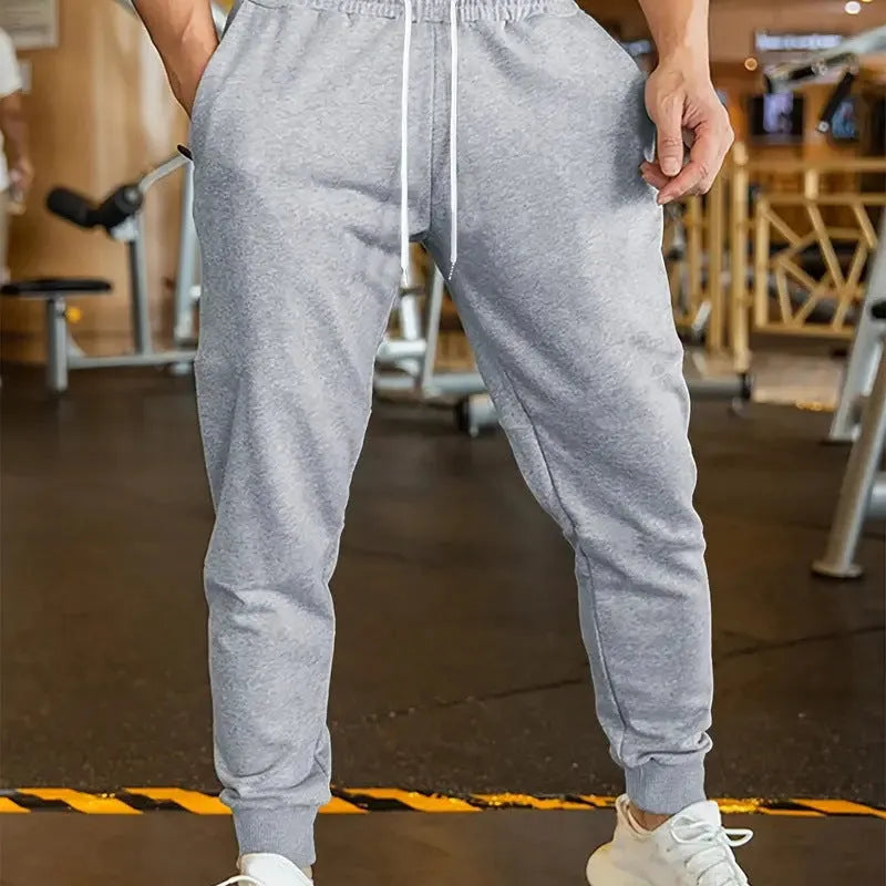 Men's loose-fit linen style leisure trousers with an elastic drawstring waist.