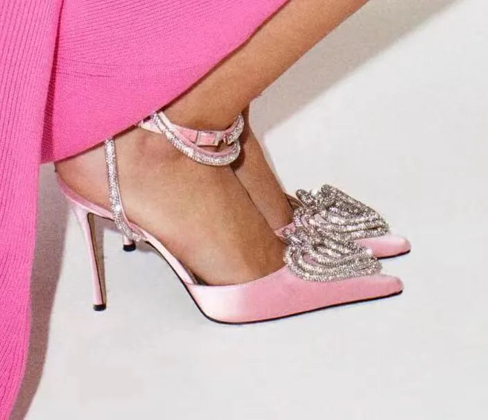 Women's pink satin sandals with pointed toe, heart-shaped rhinestone decoration, and ankle winding tape.
